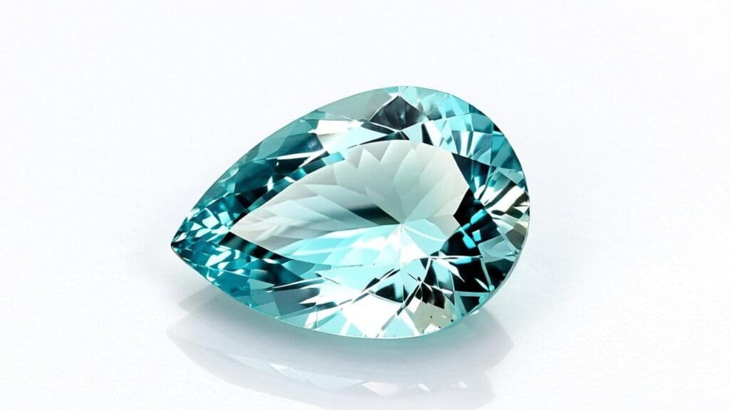 Pear-cut synthetic overgrowth aquamarine gemstone with a light blue hue and brilliant facets.