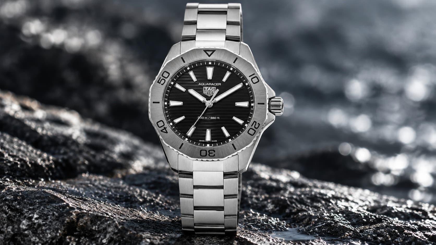 TAG Heuer Aquaracer dive watch with a black dial and steel bracelet