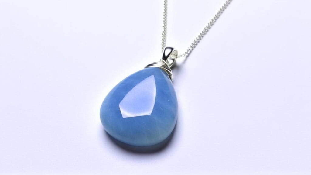 Teardrop-shaped Angelite pendant with a silver chain, featuring a soft blue hue and smooth polished finish