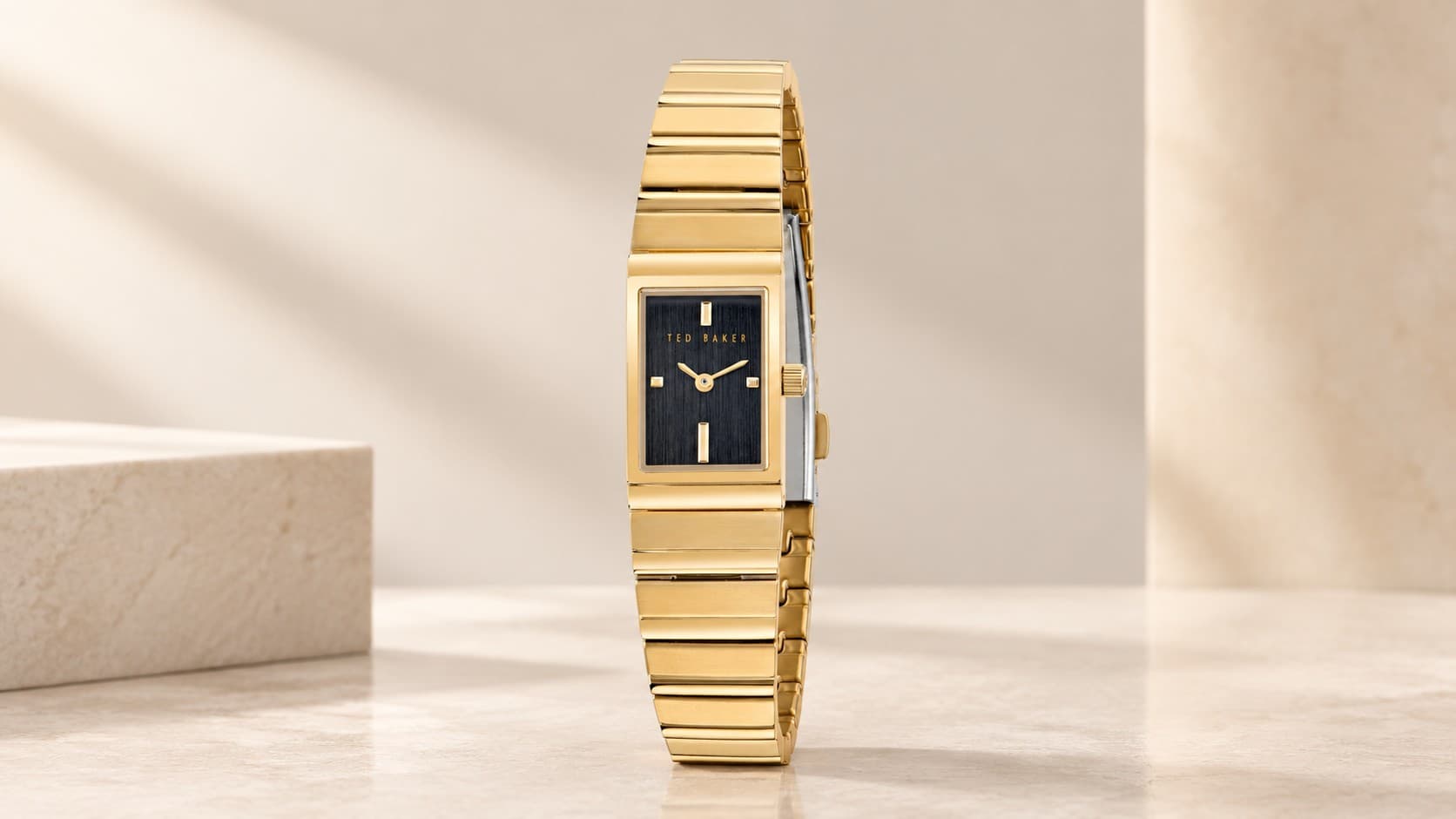 Ted Baker Lileey watch with a gold-tone rectangular case, black dial, and gold-tone link bracelet