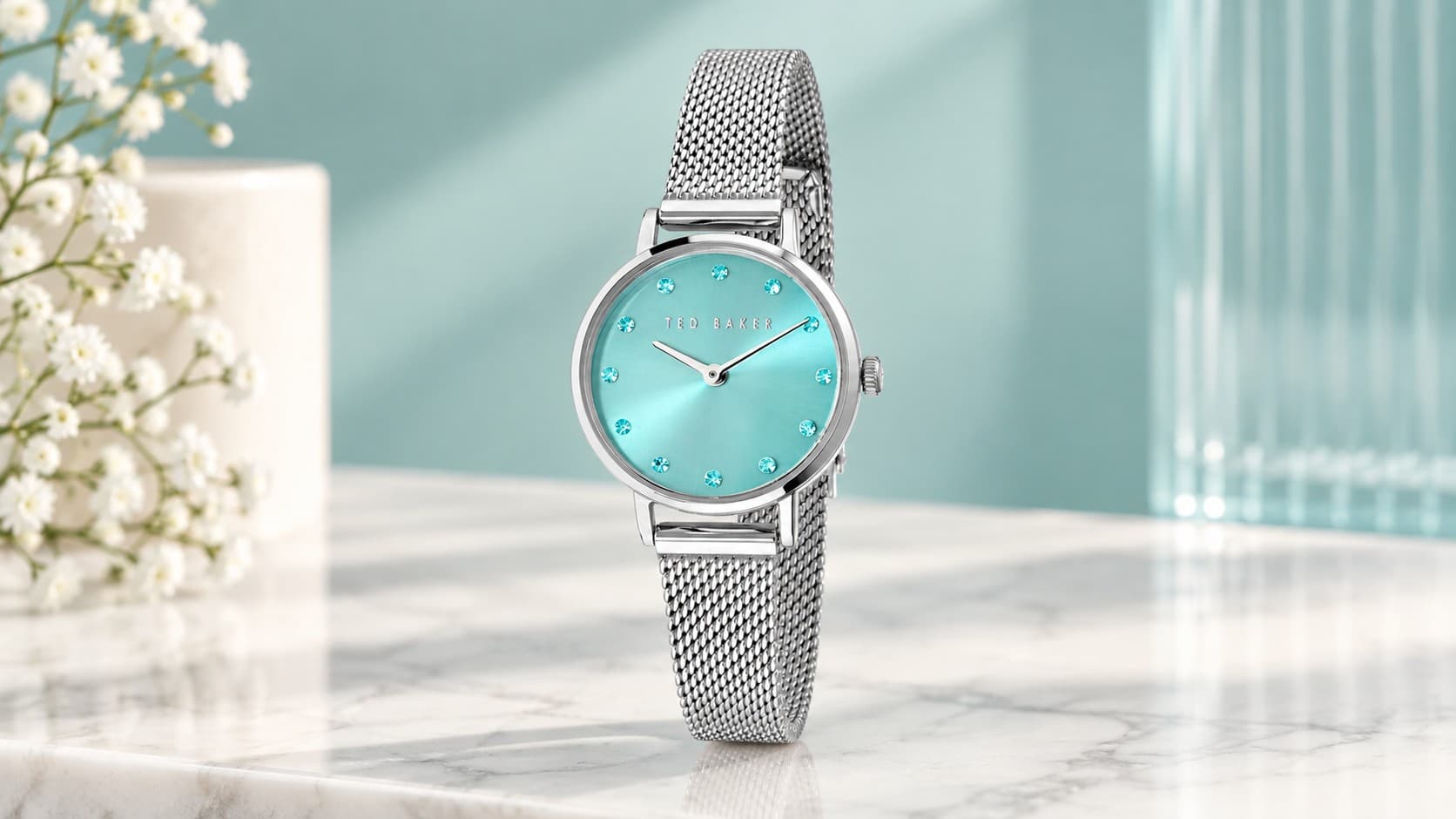 Ted Baker Staciie watch with a turquoise dial, sparkling hour markers, and silver-tone mesh bracelet