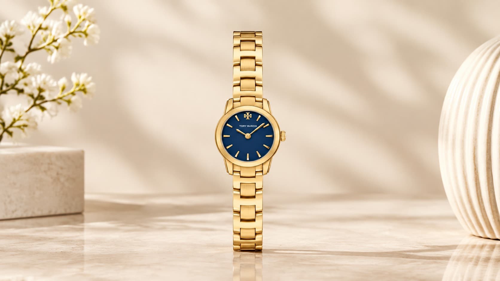 Tory Burch Mini Miller watch with gold bracelet and navy dial