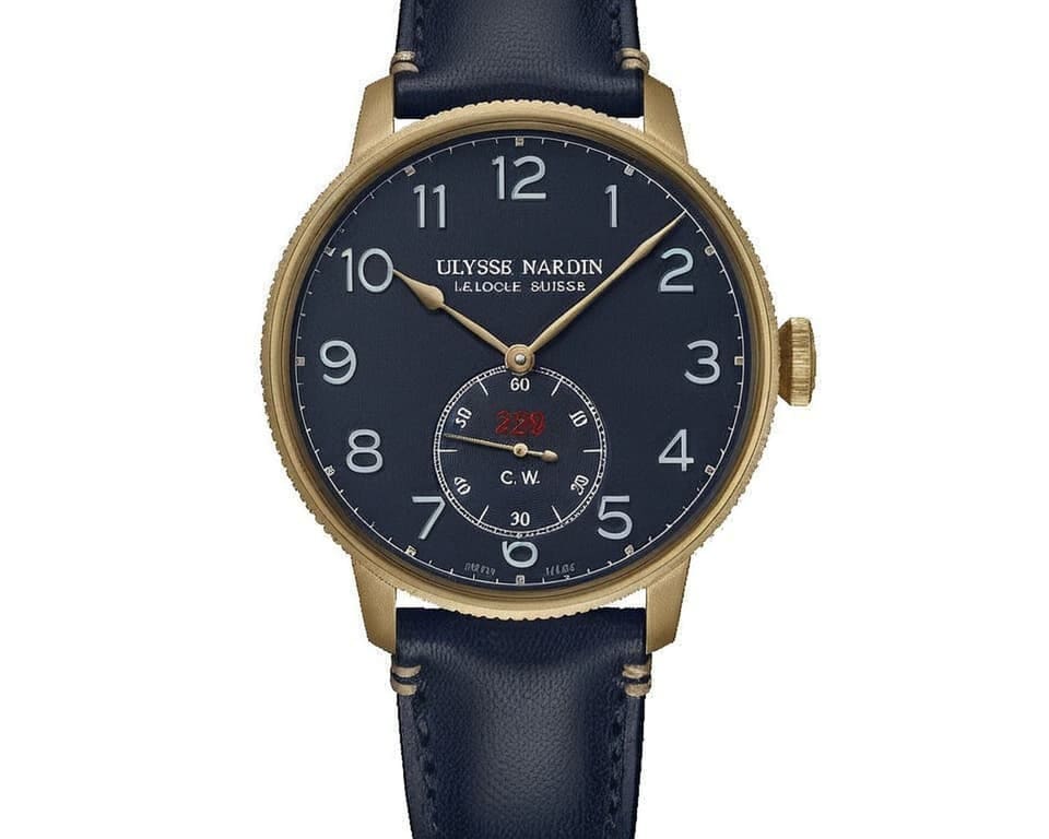 Ulysse Nardin marine watch featuring bronze case, blue dial with Arabic numerals, and leather strap representing classic Swiss watchmaking tradition