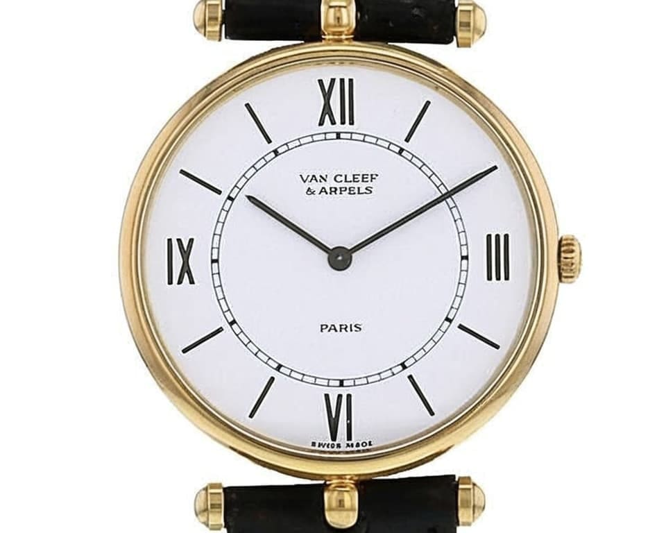 Van Cleef & Arpels Paris watch with clean white dial, Roman numerals, yellow gold case and black leather strap showing classic elegant design