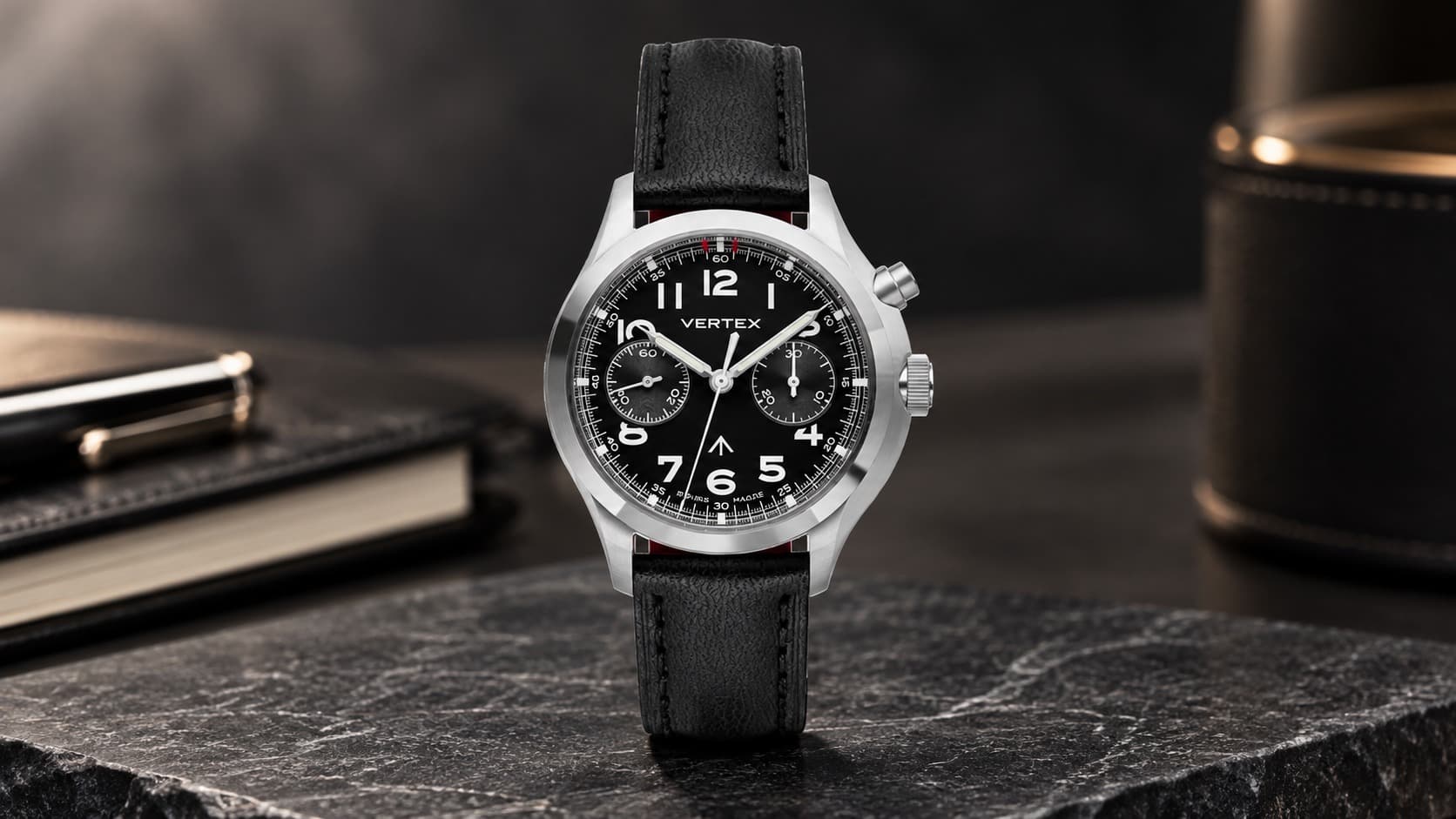 Vertex MP45 M monopusher chronograph with black leather strap resting on a dark marble surface