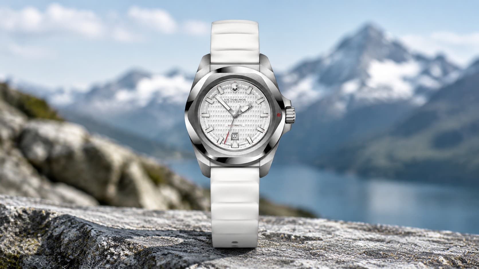 Victorinox I.N.O.X. Automatic watch with white rubber strap and mountain backdrop