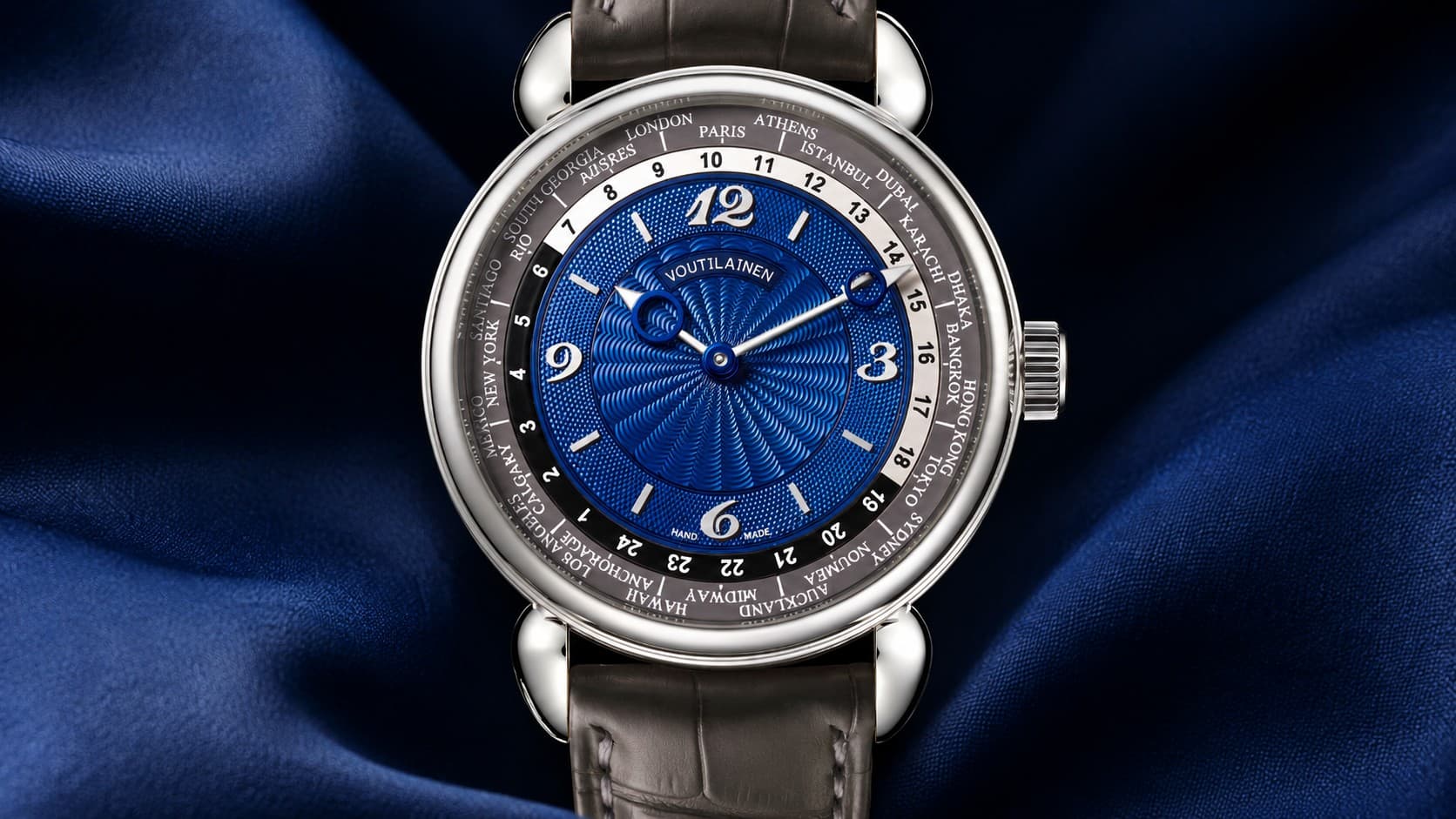 Voutilainen 216TMZ worldtimer watch with blue guilloché dial and world time ring