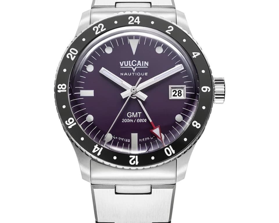 Vulcain Nautique GMT dive watch with purple gradient dial, 24-hour bezel, date window, red GMT hand, and stainless steel bracelet with 200m water resistance