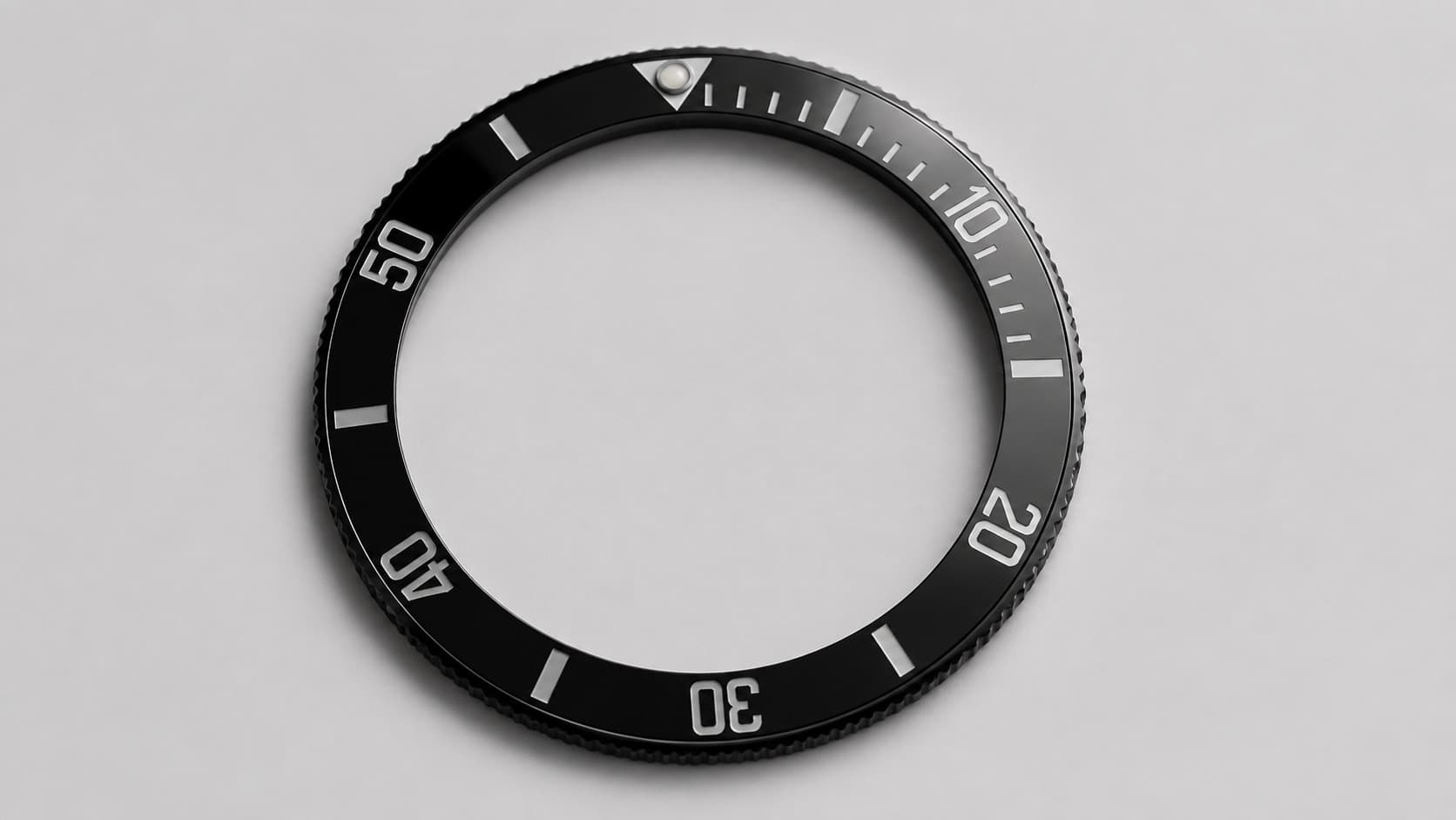 Black ceramic dive watch bezel with numbered minute markers