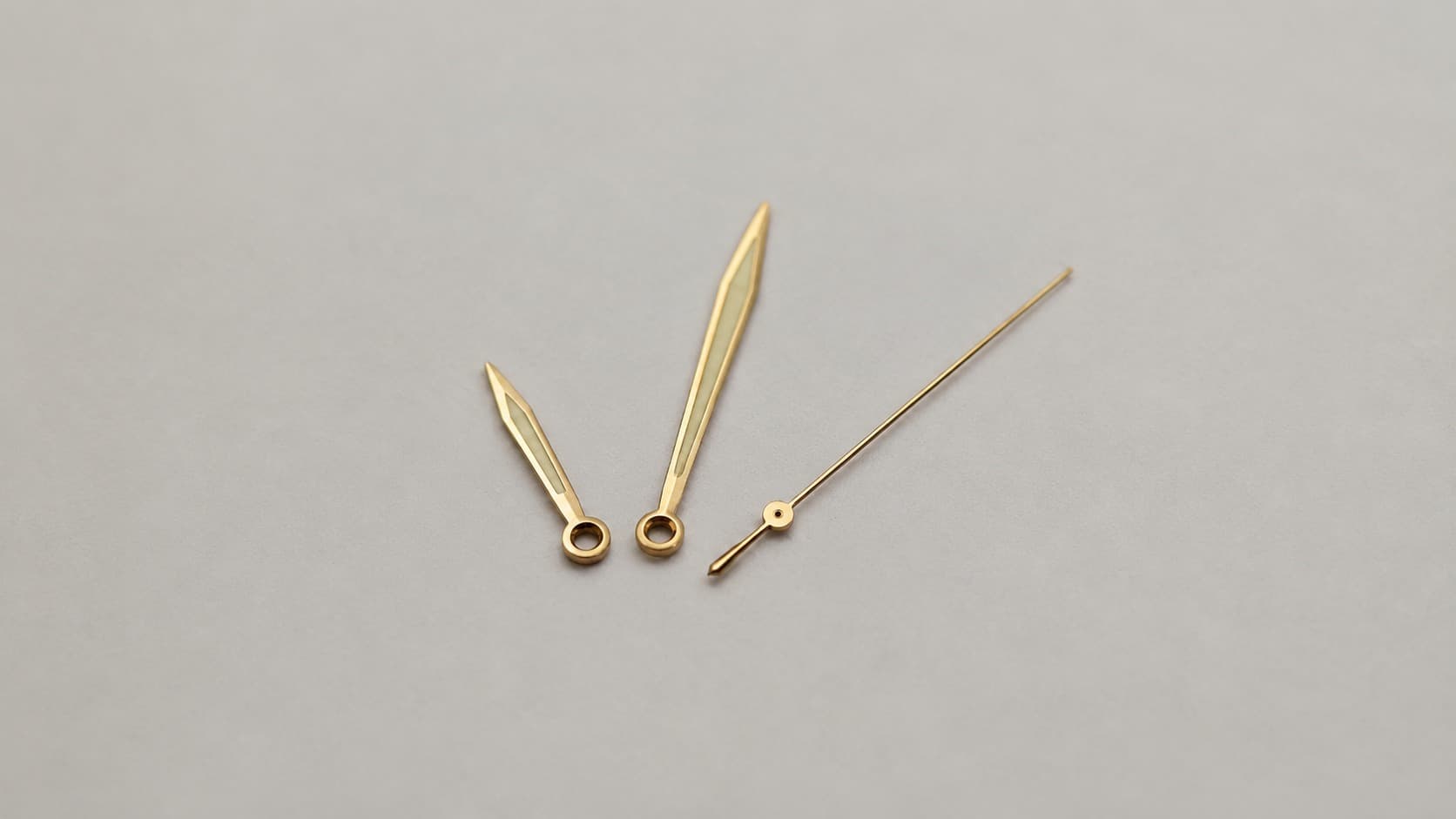 Set of gold watch hands for hour, minute, and second