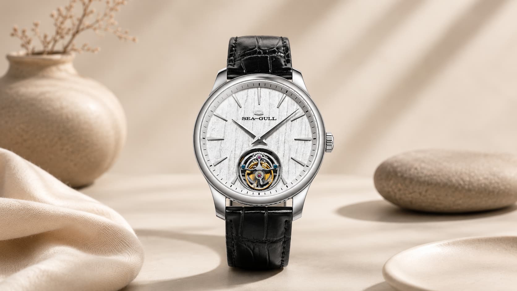 Close-up of a wristwatch dial with a visible rotating tourbillon mechanism