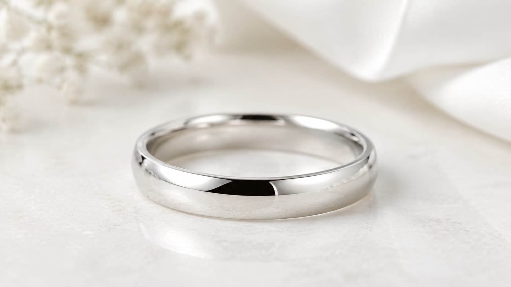 Polished white gold wedding band with a smooth rounded profile