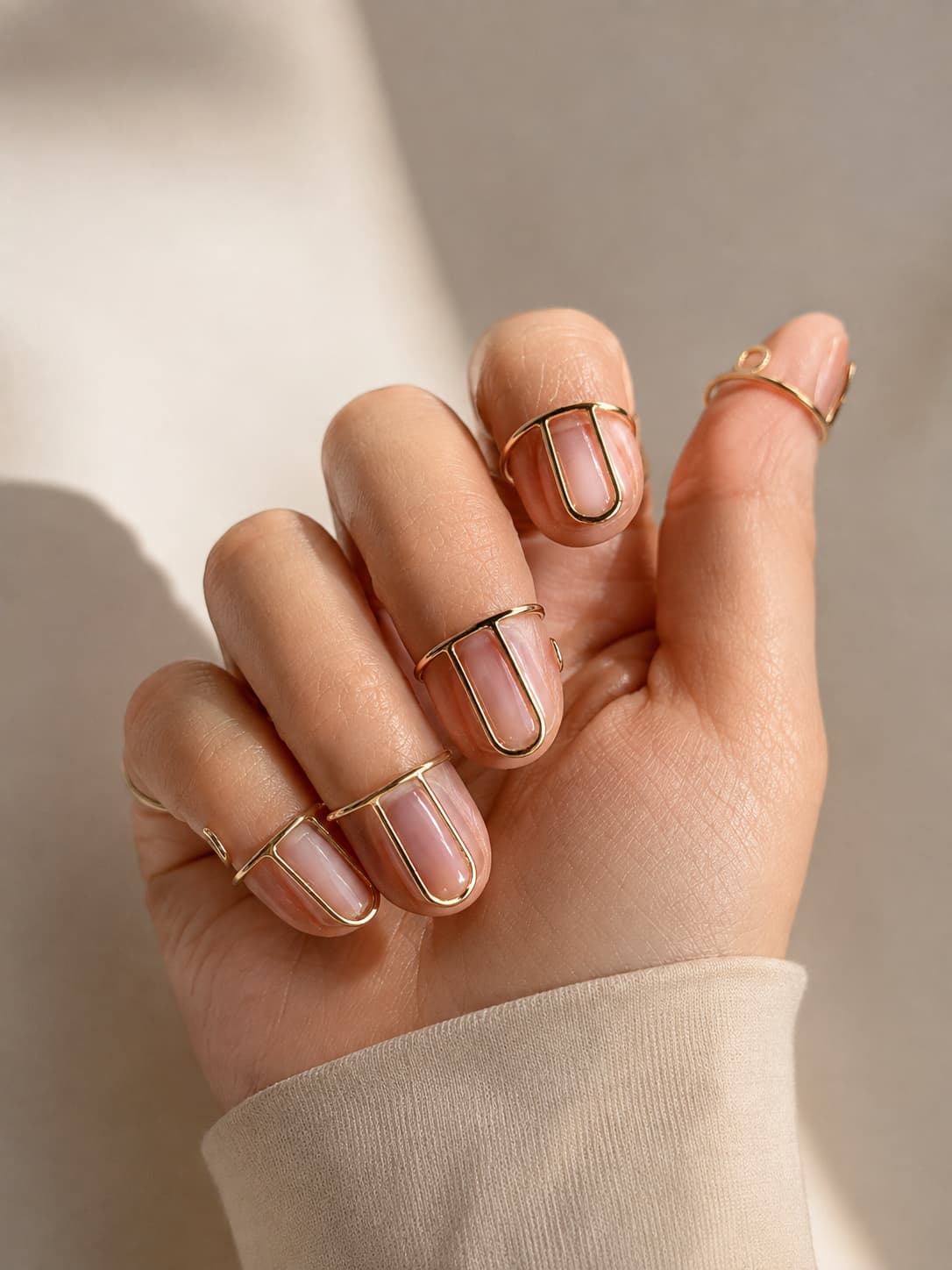 Gold wudu nail rings worn over natural, unpolished nails