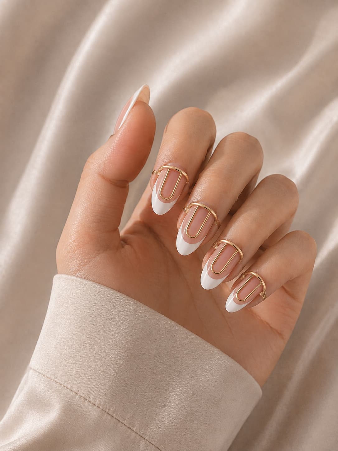 Gold wudu nail ring worn over a white French tip manicure