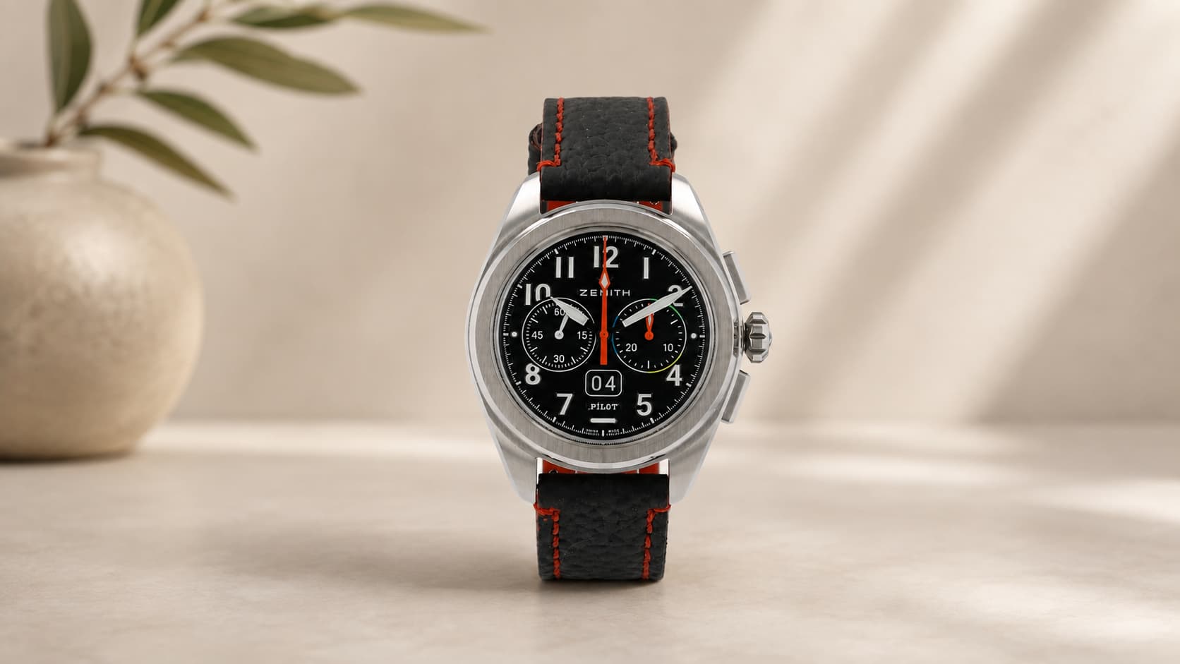 Zenith Pilot Big Date Flyback chronograph watch with black dial and orange-stitched strap