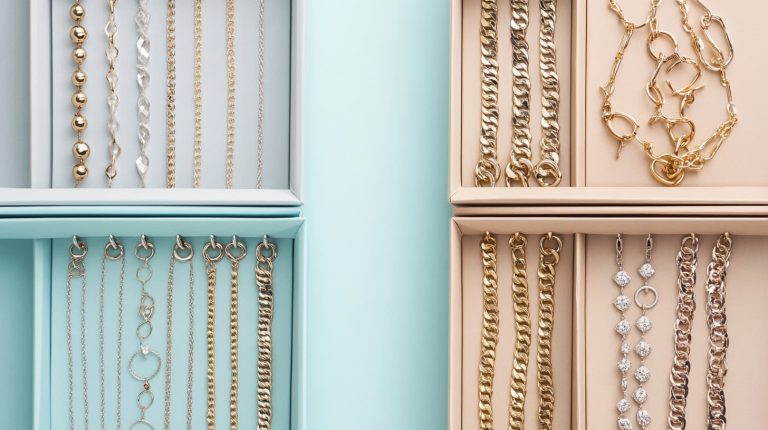 Organized jewelry storage boxes with neatly separated gold chains, bracelets, and earrings, demonstrating tangle-free packing for a move.