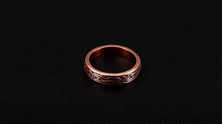 Copper alloy ring with decorative engravings, a metal that can react with skin oils and sweat, leading to green discoloration and potential irritation.