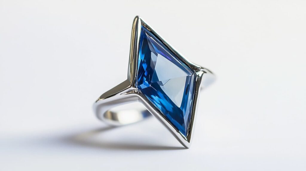 A striking blue kite-cut gemstone set in a modern white gold ring, showcasing its unique geometric shape and brilliant facets.