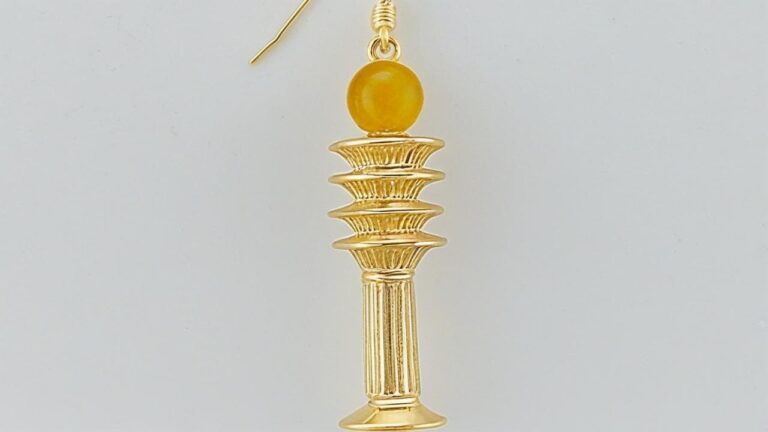Gold Djed pillar earring with intricate detailing and a yellow gemstone accent, inspired by ancient Egyptian jewelry.