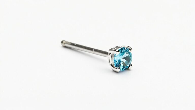 Silver nose stud with prong-set blue gemstone on straight post for nostril piercing