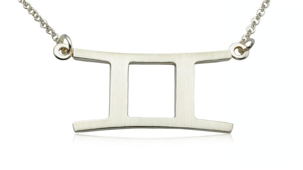 Modern minimalist sterling silver Gemini zodiac symbol necklace featuring the classic twins representation
