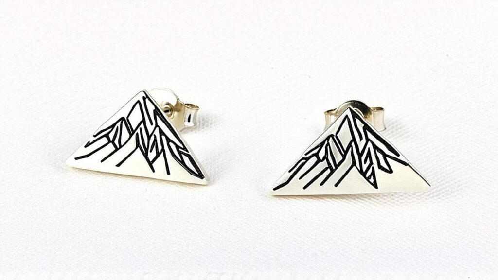 Modern silver triangle stud earrings with minimalist mountain line design, perfect for everyday wear and subtle mountain symbolism