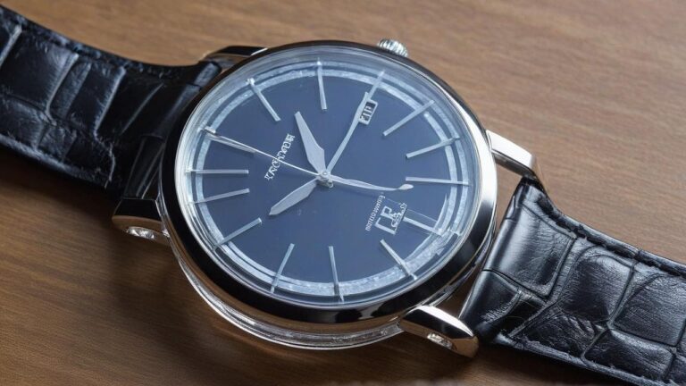 Blue dial watch with visible condensation inside the crystal on wooden surface