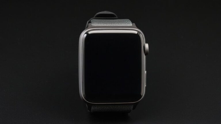 Modern black smartwatch with digital touchscreen display and mesh metal band on dark background