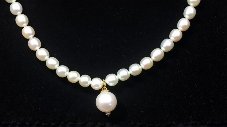 White pearl necklace with pendant requiring professional jewelry appraisal and valuation