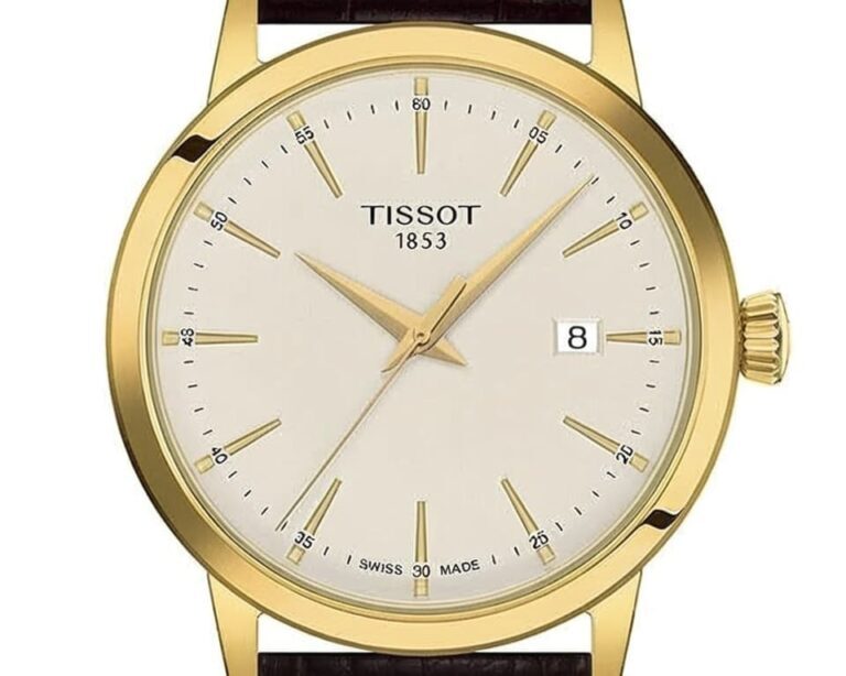 Tissot Swiss made watch with gold case and cream colored dial showing classic dress watch design and quality craftsmanship
