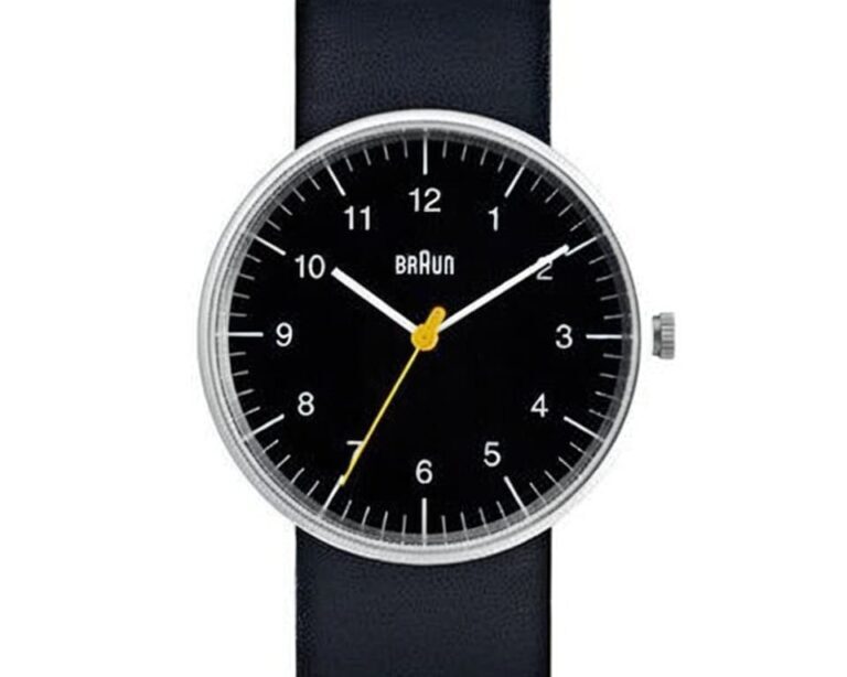 Braun watch with black dial featuring signature yellow seconds hand, white numerals, and black leather strap showcasing German minimalist design