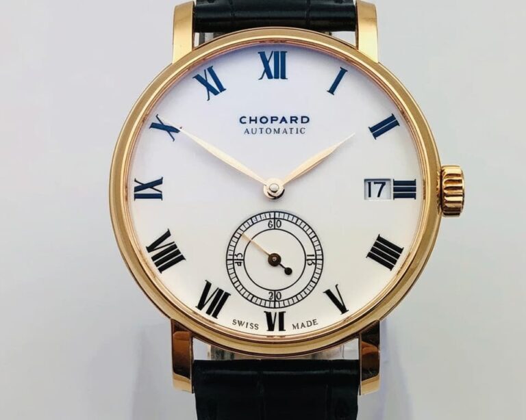 Chopard automatic watch in gold case with white dial, Roman numeral hour markers, small seconds subdial, and black leather strap