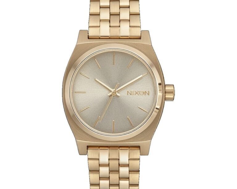 Nixon Time Teller watch in gold tone with matching bracelet, champagne sunburst dial, stick markers, and minimalist three-hand design