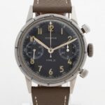Vintage Dodane Type 21 French Air Force flyback chronograph showing aged luminous numerals, bi-compax dial layout, and brown leather strap