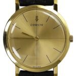Vintage Corum gold-tone watch with plain dial and black leather strap